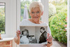 Barbara Campbell holding a photo of her mum Queenie Miller chatting with the late Duke of Edinburgh,