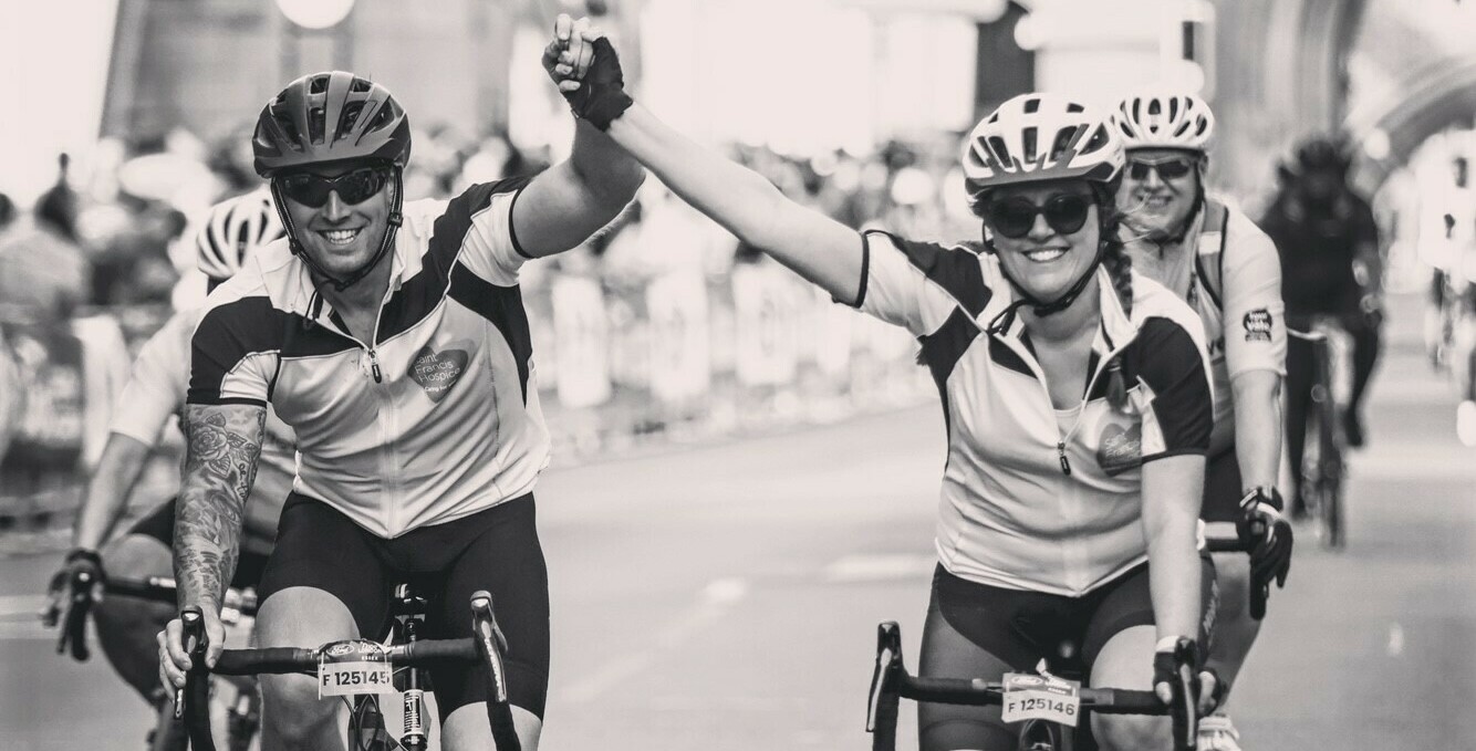 Beth and charlie crossing the finish line at Tower Bridge (cropped)