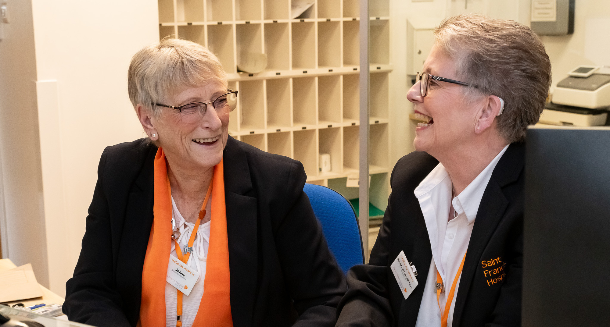 Volunteer receptionists Jenny and Belinda enjoying their shift (cropped)